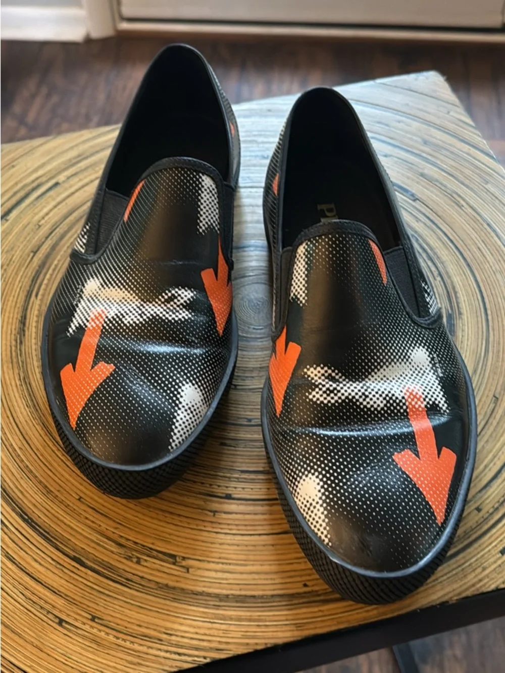 Prada Black Leather Slip-On Loafers with Orange Arrow Motif